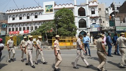 Security personnel stand guard on Monday at Jahangirpuri in New Delhi after clashes broke out between two communities during a Hanuman Jayanti procession on Saturday,