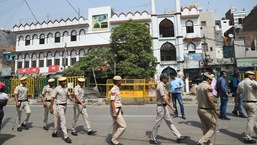 Security personnel stand guard on Monday at Jahangirpuri in New Delhi after clashes broke out between two communities during a Hanuman Jayanti procession on Saturday,