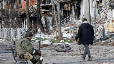 A service member of pro-Russian troops sits on a chair in a street near a building, which was destroyed during Ukraine-Russia conflict in the southern port city of Mariupol, Ukraine (REUTERS) A service member of pro-Russian troops sits on a chair in a street near a building, which was destroyed during Ukraine-Russia conflict in the southern port city of Mariupol, Ukraine (REUTERS)
