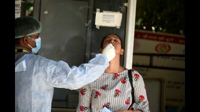 A health worker collecting swab sample for Covid-19 testing at a polyclinic in Huda Market, Gurugram, on Saturday. (HT Photo) A health worker collecting swab sample for Covid-19 testing at a polyclinic in Huda Market, Gurugram, on Saturday. (HT Photo)