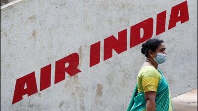 A woman walks past an Air India signboard in Mumbai. (REUTERS PHOTO)