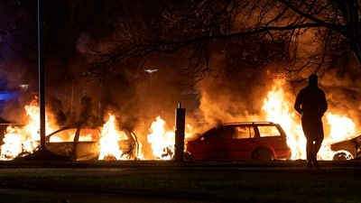 Cars are engulfed by flames after protests broke out at Rosengard in Malmo, Sweden. (AP) Cars are engulfed by flames after protests broke out at Rosengard in Malmo, Sweden. (AP)