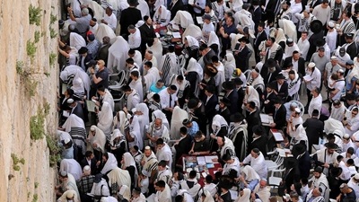 Jewish worshippers take part in the Cohanim prayer (priest's blessing) during the Passover holiday at the Western Wall in Jerusalem's Old City. (AFP) Jewish worshippers take part in the Cohanim prayer (priest's blessing) during the Passover holiday at the Western Wall in Jerusalem's Old City. (AFP)