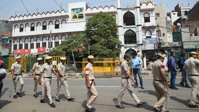 Security personnel stand guard on Monday at Jahangirpuri in New Delhi after clashes broke out between two communities during a Hanuman Jayanti procession on Saturday, (PTI) Security personnel stand guard on Monday at Jahangirpuri in New Delhi after clashes broke out between two communities during a Hanuman Jayanti procession on Saturday, (PTI)