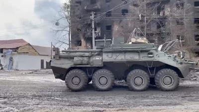 A military vehicle is seen in front of a damaged building in Trostyanets, as Russia's invasion of Ukraine continues. (via REUTERS)