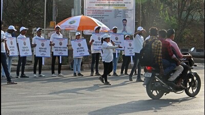Volunteers stand at Radha chowk, Baner as part of traffic awareness week will be observed from April 18-23. (Ravindra Joshi/HT PHOTO)