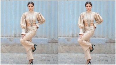 Rubina paired a pastel gold cropped top with turtleneck details and voluminous sleeves and frills with a pair of high-waisted pastel gold trousers with wide legs. (Instagram/@rubinadilaik)