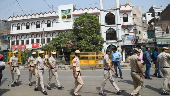 Security personnel stand guard on Monday at Jahangirpuri in New Delhi after clashes broke out between two communities during a Hanuman Jayanti procession on Saturday,(PTI)