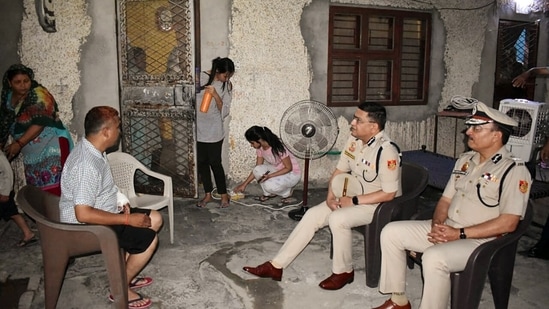 Delhi Police Commissioner Rakesh Asthana meets Sub-Inspector Meda Lal, who sustained a bullet injury during the violence in Jahangirpuri, at his residence, in New Delhi.(ANI)