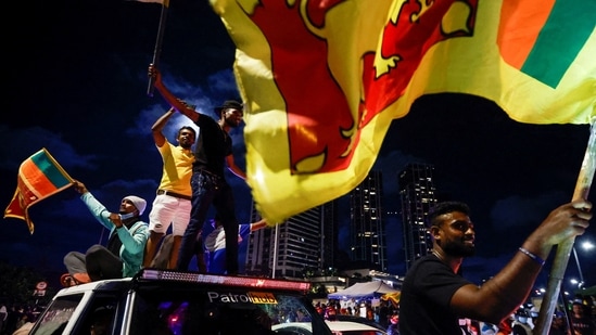 A demonstrator holds a Sri Lankan national flag during a protest against Sri Lankan President Gotabaya Rajapaksa in Colombo.(REUTERS)