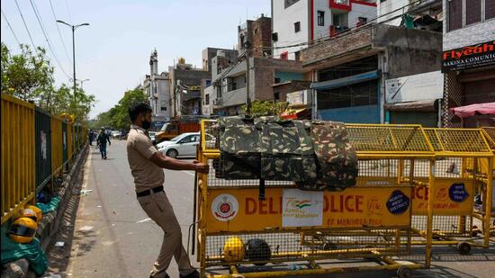 Security forces place barricades at the site of communal clash during a religious procession in Delhi’s Jahangirpuri area (HT Photo/Amal KS)