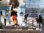 Protesters burn a barricade at the entrance to a shopping center during rioting in Norrkoping, Sweden (Photo by Stefan JERREVANG / various sources / AFP) (AFP) Protesters burn a barricade at the entrance to a shopping center during rioting in Norrkoping, Sweden (Photo by Stefan JERREVANG / various sources / AFP) (AFP)