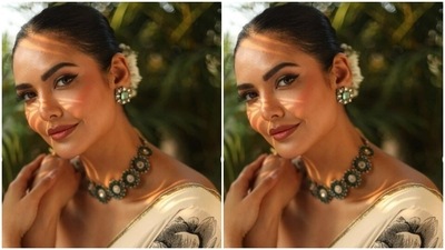 Styled by fashion stylist Chandini Whabi, Esha accessorised her look with emerald stone-studded choker and ear studs. She wore her tresses into a clean bun and added fresh flowers to it. (Instagram/@egupta)