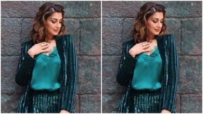 Sonali paired a soft blue satin top with lace details with a shimmery blue blazer lined in black sequin. She teamed her look with a pair of trousers of the same fabric. (Instagram/@iamsonalibendre)