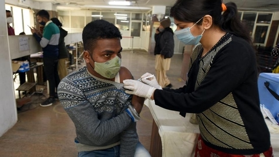 A person gets a dose of Covid-19 vaccine at the district hospital in Noida on Sunday.&nbsp;(HT file)