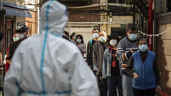Residents of Shanghai wait to get tested for Covid-19 amid lockdown in China on Monday. (Bloomberg Photo)