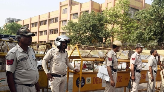 New Delhi, Apr 18 (ANI): Police personnel stand guard at a site where the Delhi Police Crime Branch team members were targeted on Monday.&nbsp;(ANI)