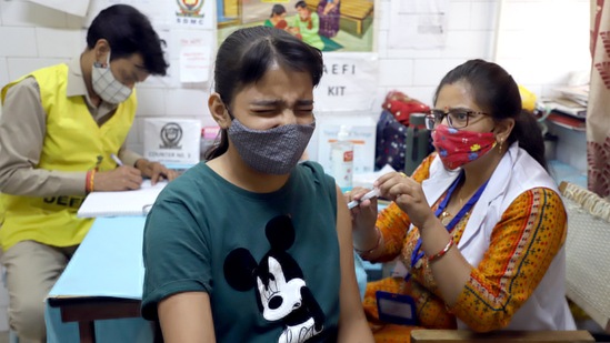 A beneficiary reacts while receiving a dose of Covid-19 vaccine during a vaccination drive for the 12-14 years of age group at a dispensary Daryaganj in New Delhi on Tuesday.&nbsp;(ANI )