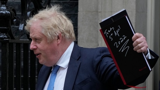 Britain's Prime Minister Boris Johnson waves to the media as he leaves 10 Downing Street for the House of Commons in London on Tuesday.(AP)