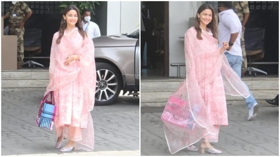Alia styled the elegant ensemble with mojari sandals decorated with floral embellishments, her diamond-adorned engagement ring, and dainty jhumkis. She also carried a colourful printed Christian Dior tote bag with the airport look.(HT Photo/Varinder Chawla)