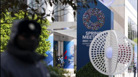 IMF police officers stand outside of the International Monetary Fund (IMF) building, during the first day of the World Bank/IMF Spring meetings in Washington, on Tuesday. (AP)