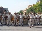 Police personnel stand guard at the incident site where a clash broke out between two communities during the procession on Hanuman Jayanti, at Jahangirpuri, in New Delhi.(ANI)