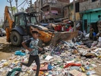 A woman resident reacts during a joint anti-encroachment drive by NDMC, PWD, local bodies and the police, in the violence-hit Jahangirpuri area, in New Delhi, Wednesday, April 20, 2022. (PTI Photo) (PTI04_20_2022_000045B)