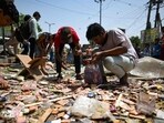 Residents look through the rubble after the North Delhi Municipal Corporation razed shops during an anti-encroachment drive in Jahangirpuri in New Delhi on Wednesday, April 20, 2022. (Amal KS/HT Photo)