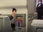 As the announcement was being made, a passenger took off the mask and waved in the air. (Screenshot from viral video/Bloomberg Quick Take)