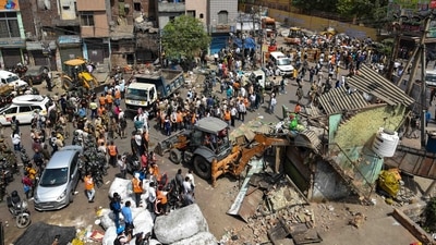 An aerial view shows a bulldozer demolishing an illegal structure, in Jahangirpuri, New Delhi, on April 20, 2022. The demolition drive continued even after the apex court directed the authorities to stop it. Officials said it was because of the absence of a written order from the court. (Amal KS / HT Photo) An aerial view shows a bulldozer demolishing an illegal structure, in Jahangirpuri, New Delhi, on April 20, 2022. The demolition drive continued even after the apex court directed the authorities to stop it. Officials said it was because of the absence of a written order from the court. (Amal KS / HT Photo)