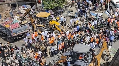 Bulldozers in violence-hit Jahangirpuri. (PTI) Bulldozers in violence-hit Jahangirpuri. (PTI)