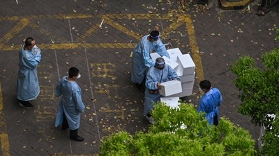 Workers wearing protective gear stack boxes during a Covid-19 coronavirus lockdown in the Jing'an district in Shanghai on April 20, 2022. (Representational image) (AFP)