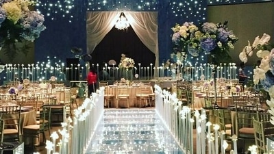 2. Dreamy and whimsical decor - When it comes to creativity, wedding decorators leave no stone unturned and another great way that you can never go wrong with is dreamy &amp; whimsical decor. Since it makes a statement without being obtrusive, it’s gaining a lot of traction these days. Mixing and matching colours would be ideal for this kind of wedding. The most fun colours for a whimsical feel would be pastel shades with that foliage and climbing vines along the arms of the aisle chairs, this can also be added for a more rustic vibe. Coloured canopies and fabrics can also be utilised to create this form of decor, which enhances the appearance of areas. Entry passages that are decked up beautifully inspired by fairy tales, huge floral installations like chandeliers, neon signages, reflecting surfaces, etc are also becoming popular trends for 2022, when it comes to dream and whimsical decors.&nbsp; (Twitter/TheBrideStory)