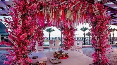 3. Floral Decor - This will take centre stage as no matter the theme, flowers have always held a special place in wedding decor! While enhancing the beauty of any space, suspended floral installations are the new trend that’s lately been impressing everyone! Bringing the most beautiful ‘bageecha’ to life in the venue and mandap area has become one of the most popular trends of Indian weddings. Expect aesthetically beautiful genda phool arrangements in jute or bamboo containers, floral chandeliers, and centrepieces for seating arrangements, flower-filled stages and swings are gaining popularity. You can also opt for flowers like Tuberoses, Orchids, Roses, Lilies, Chrysanthemums and Hydrangeas for your big day decor.&nbsp; (Twitter/eventsglobal_co)