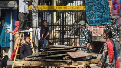 People shift their belongings during a joint anti-encroachment drive by the NDMC, PWD and the police in the violence-hit Jahangirpuri on April 20, 2022. (PTI photo) People shift their belongings during a joint anti-encroachment drive by the NDMC, PWD and the police in the violence-hit Jahangirpuri on April 20, 2022. (PTI photo)