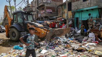 A woman resident reacts during a joint anti-encroachment drive by NDMC, PWD, local bodies and the police, in the violence-hit Jahangirpuri area, in New Delhi, Wednesday, April 20, 2022. (PTI Photo) (PTI04_20_2022_000045B) (PTI) A woman resident reacts during a joint anti-encroachment drive by NDMC, PWD, local bodies and the police, in the violence-hit Jahangirpuri area, in New Delhi, Wednesday, April 20, 2022. (PTI Photo) (PTI04_20_2022_000045B) (PTI)