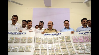 Navi Mumbai Commissioner of Police, Bipin Kumar Singh, and his team display the recovered cash amount of ₹1.25Cr at a press conference in CBD Belapur on Wednesday. Four persons were arrested for stealing ₹1.40Cr cash from a courier office in Navi Mumbai. (BACHCHAN KUMAR/HT PHOTO) Navi Mumbai Commissioner of Police, Bipin Kumar Singh, and his team display the recovered cash amount of ₹1.25Cr at a press conference in CBD Belapur on Wednesday. Four persons were arrested for stealing ₹1.40Cr cash from a courier office in Navi Mumbai. (BACHCHAN KUMAR/HT PHOTO)