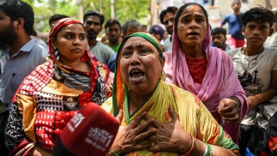 A resident breaks down while interacting with the media during the anti-encroachment drive in Jahangirpuri, New Delhi, on April 20, 2022. (Amal KS / HT Photo)
