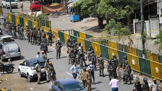 Security personnel deployed during the anti-encroachment drive carried out by North Delhi Municipal Corporation in Jahangirpuri, New Delhi, on April 20, 2022. On April 16, Jahangirpuri had witnessed violent clashes between two communities during a Hanuman Jayanti procession, where eight police personnel and a local resident were injured.(Amal KS / HT Photo)