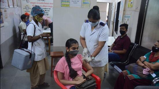 A beneficiary gets vaccinated against Covid-19 in Thane on Wednesday. Praful Gangurde/HT Photo