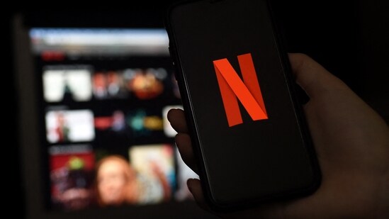 In this file photo illustration a computer and a mobile phone screens display the Netflix logo on March 31, 2020 in Arlington, Virginia.(AFP)