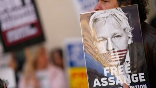 Wikileaks founder Julian Assange supporters hold placards as they gather outside Westminster Magistrates court In London, Wednesday, April 20, 2022.&nbsp;(AP)