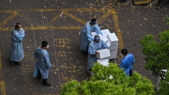 Workers wearing protective gear stack boxes during a Covid-19 coronavirus lockdown in the Jing'an district in Shanghai on April 20, 2022. (Representational image) (AFP)