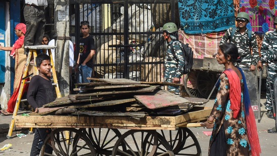 People shift their belongings during a joint anti-encroachment drive by the NDMC, PWD and the police in the violence-hit Jahangirpuri on April 20, 2022. (PTI photo)