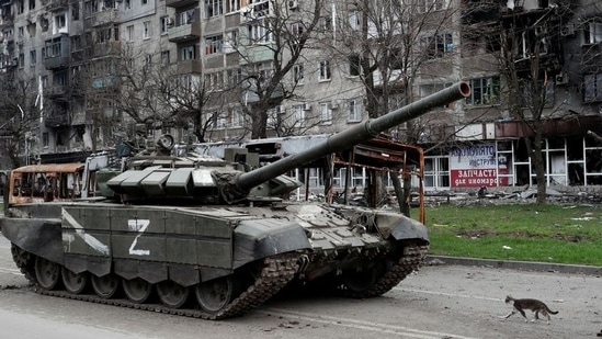 A tank of pro-Russian troops in front of an apartment building damaged during Ukraine-Russia conflict in the southern port city of Mariupol, Ukraine on Tuesday.&nbsp;