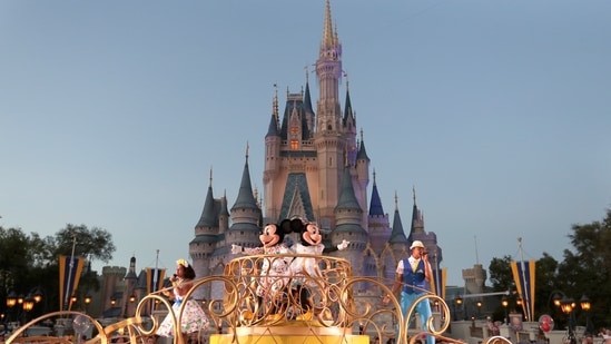 Mickey and Minnie Mouse perform during a parade as they pass by the Cinderella Castle at the Magic Kingdom theme park at Walt Disney World (AP)