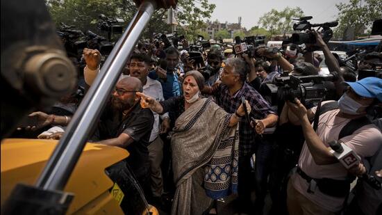 Communist Party of India (Marxist) leader Brinda Karat stands in front of a bulldozer during the demolition of shops in New Delhi's Jahangirpuri in New Delhi on Wednesday. (AP)