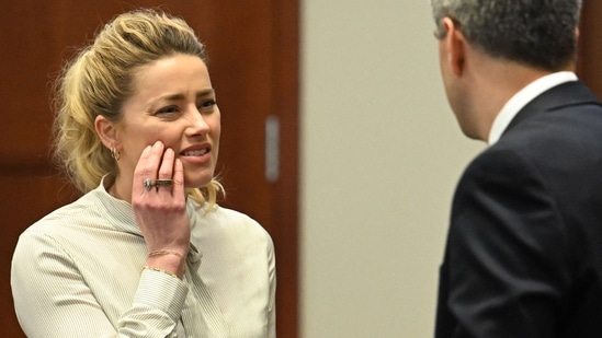 US actress Amber Heard looks on during a trial in the Fairfax County Circuit Courthouse in Fairfax, Virginia, on April 19, 2022. - US actor Johnny Depp is suing ex-wife Amber Heard for libel after she wrote an op-ed piece in The Washington Post in 2018 referring to herself as a �public figure representing domestic abuse.� (Photo by JIM WATSON / POOL / AFP)(AFP)