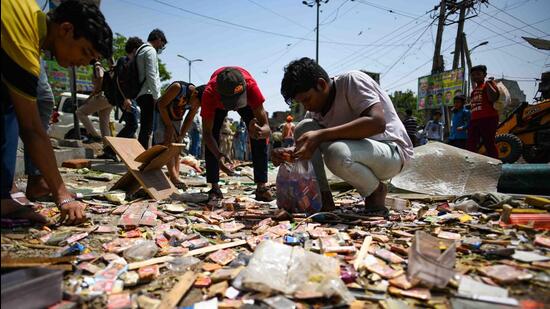 Residents look through the rubble after the North Delhi Municipal Corporation razed shops during an anti-encroachment drive in Jahangirpuri in New Delhi on Wednesday, April 20, 2022. (Amal KS/HT Photo)