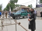 Taliban fighters stand guard at the site of an explosion in Kabul, Afghanistan, April 19.